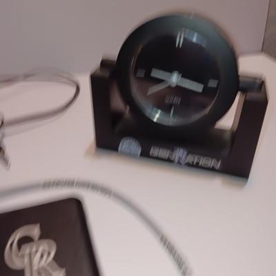 Colorado Rockies marked electronic gadgets - speaker - charger - clock - with coasters and a glasses neck band.