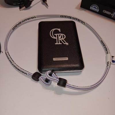 Colorado Rockies marked electronic gadgets - speaker - charger - clock - with coasters and a glasses neck band.