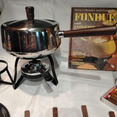 Fondue set pot, burner, and servers with Fondue and tabletop cooking cookbook.