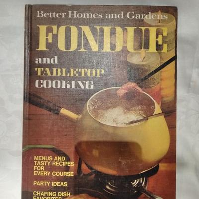 Fondue set pot, burner, and servers with Fondue and tabletop cooking cookbook.