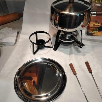 Fondue set pot, burner, and servers with Fondue and tabletop cooking cookbook.