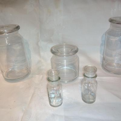 Collection of glass canisters and spice / pharmacy jars with lids