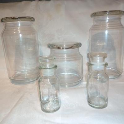 Collection of glass canisters and spice / pharmacy jars with lids