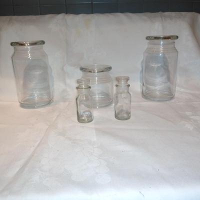 Collection of glass canisters and spice / pharmacy jars with lids