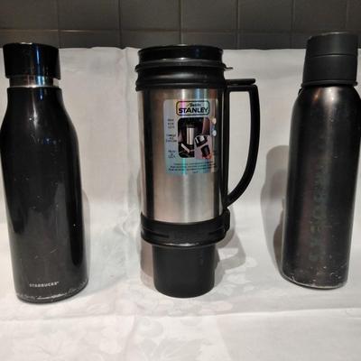 Stanley travel mug and two metal water bottles