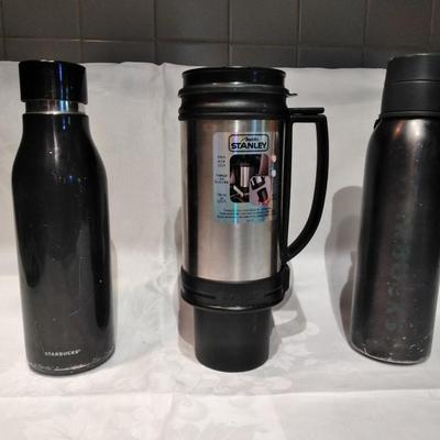 Stanley travel mug and two metal water bottles