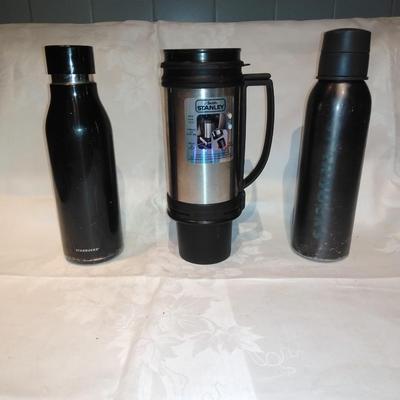 Stanley travel mug and two metal water bottles