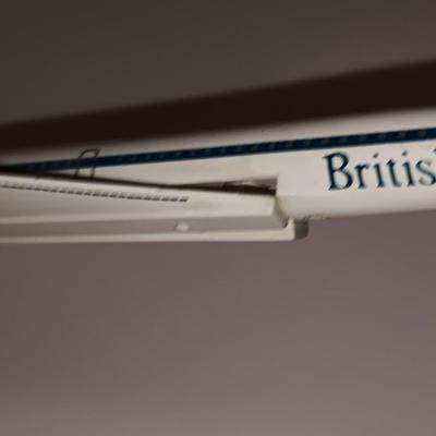 Three vintage metal airplanes and one British airlines model