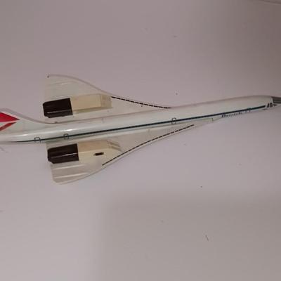 Three vintage metal airplanes and one British airlines model