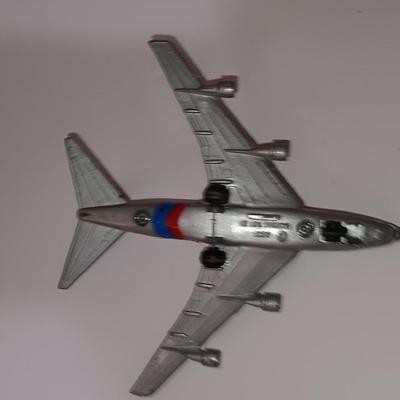 Three vintage metal airplanes and one British airlines model