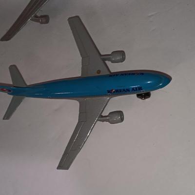 Three vintage metal airplanes and one British airlines model