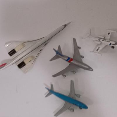 Three vintage metal airplanes and one British airlines model