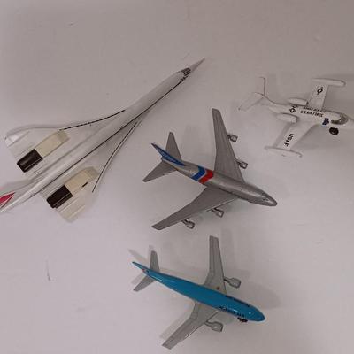 Three vintage metal airplanes and one British airlines model