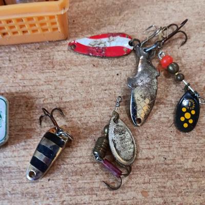 Fishing lures with green canvas military bag