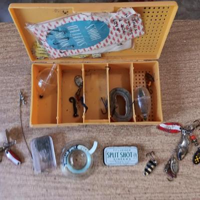 Fishing lures with green canvas military bag