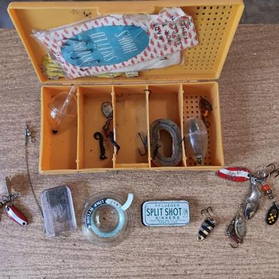 Fishing lures with green canvas military bag