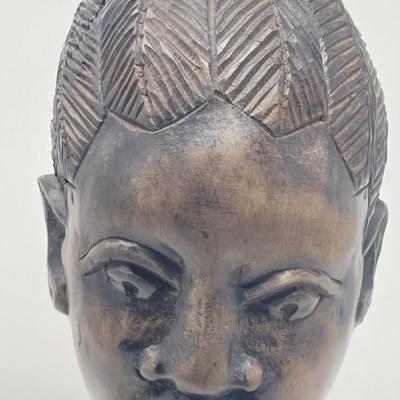 Female statue with up turned hair