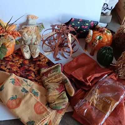 Fall Decorations for your home - pumpkins - scarecrow - tablecloth- miniature straw bales.