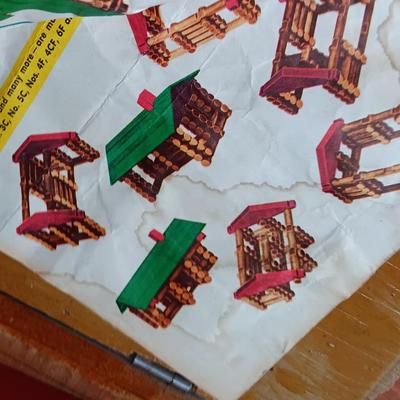 Vintage Lincoln logs in a wooden box with instructions