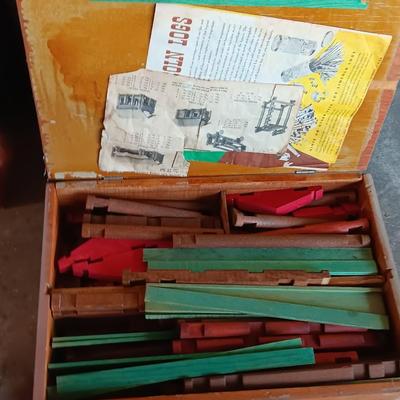 Vintage Lincoln logs in a wooden box with instructions