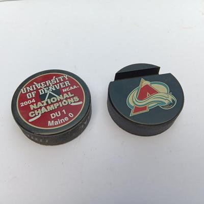 Colorado Avalanche hockey puck and University of Denver 2004 NCAA National Champs puck