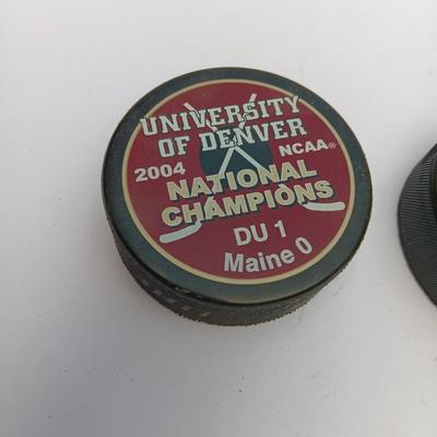 Colorado Avalanche hockey puck and University of Denver 2004 NCAA National Champs puck