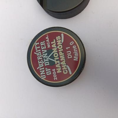 Colorado Avalanche hockey puck and University of Denver 2004 NCAA National Champs puck