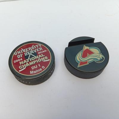 Colorado Avalanche hockey puck and University of Denver 2004 NCAA National Champs puck