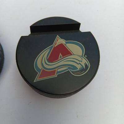 Colorado Avalanche hockey puck and University of Denver 2004 NCAA National Champs puck