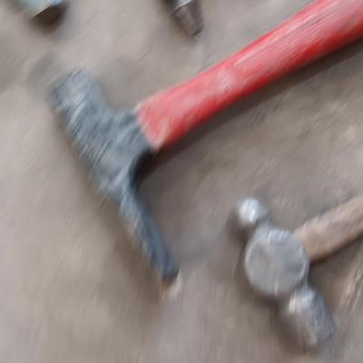 Assortment of hammers for different uses and a pipe wrench