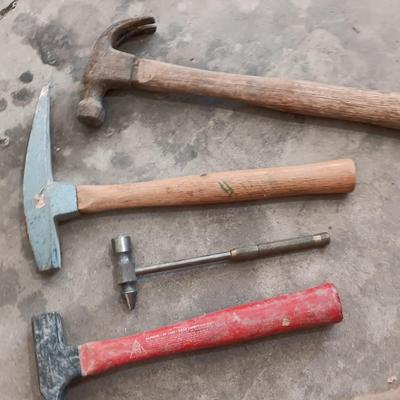 Assortment of hammers for different uses and a pipe wrench