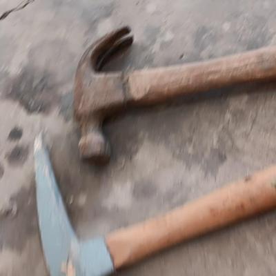 Assortment of hammers for different uses and a pipe wrench