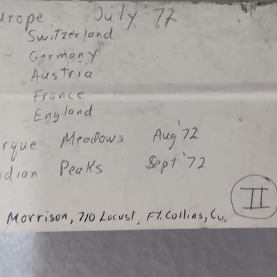 Six metal slide boxes full of slides from various travels