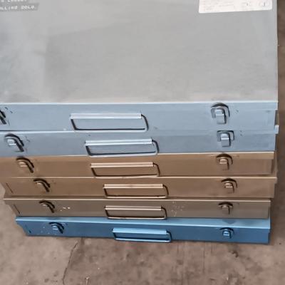 Six metal slide boxes full of slides from various travels