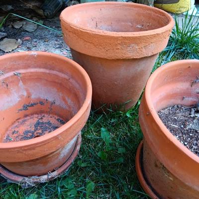 Five different sized terra cotta clay pots and some water saucers