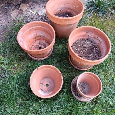 Five different sized terra cotta clay pots and some water saucers