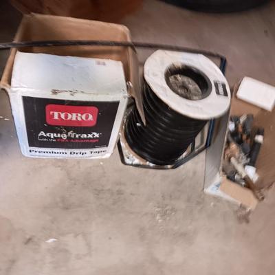 Roll of Toro Aqua-Traxx with the PBX Advantage Drip tape with small box of plumbing supplies
