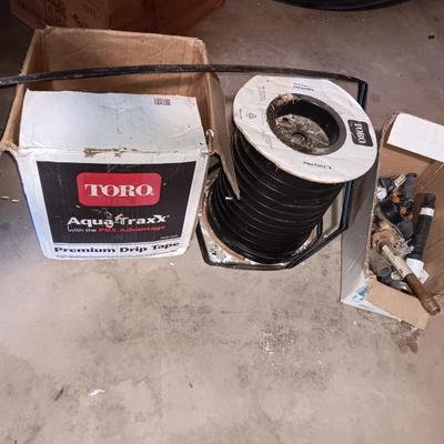 Roll of Toro Aqua-Traxx with the PBX Advantage Drip tape with small box of plumbing supplies