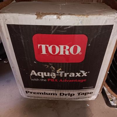 Roll of Toro Aqua-Traxx with the PBX Advantage Drip tape with small box of plumbing supplies