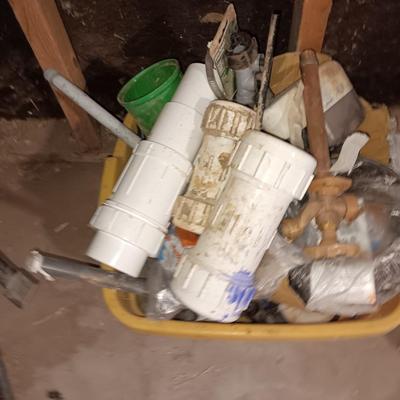 Box of misc. plumbing supplies with a bunch of hoses and water line items Small new roll of blue PEX pipe