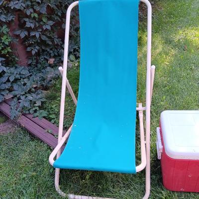 Laid back folding chair with red Coleman cooler