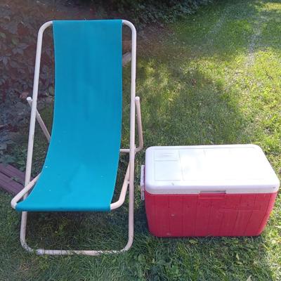 Laid back folding chair with red Coleman cooler