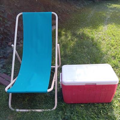 Laid back folding chair with red Coleman cooler