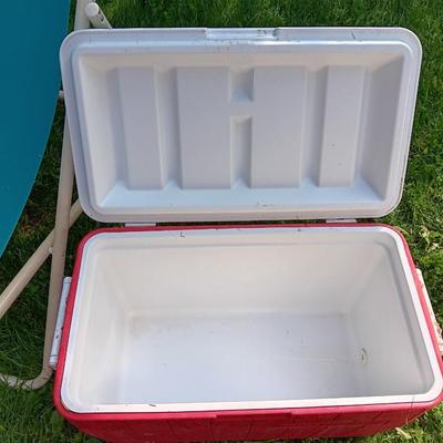 Laid back folding chair with red Coleman cooler