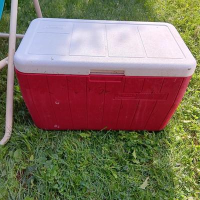 Laid back folding chair with red Coleman cooler