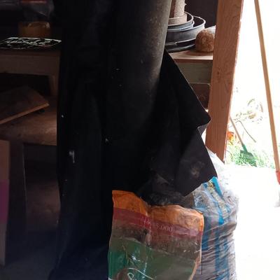 Two big rolls of weed barrier Garden fabric - lawn edging - and bag of lawn winterizer and mulch