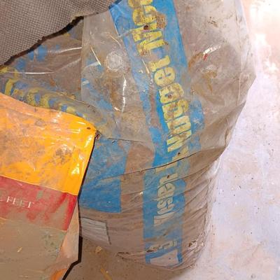 Two big rolls of weed barrier Garden fabric - lawn edging - and bag of lawn winterizer and mulch