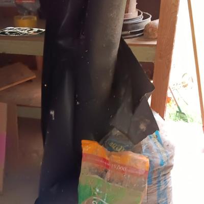 Two big rolls of weed barrier Garden fabric - lawn edging - and bag of lawn winterizer and mulch