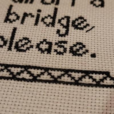 Cross Stitched "Fall Off A Bridge Please" by Local Artist