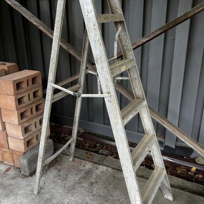 Behind GARAGE -- 6 foot folding step ladder